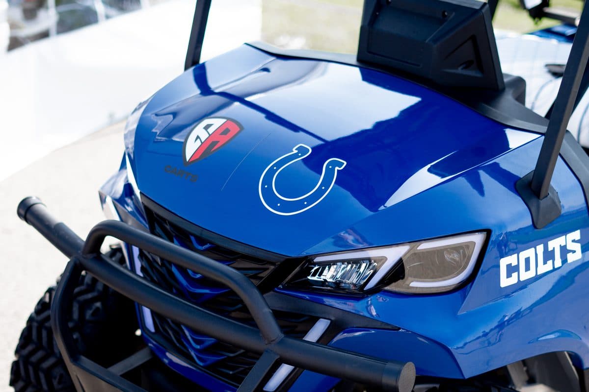 Front of a blue EA Carts golf cart with the Colts horseshoe on the hood and COLTS on the side